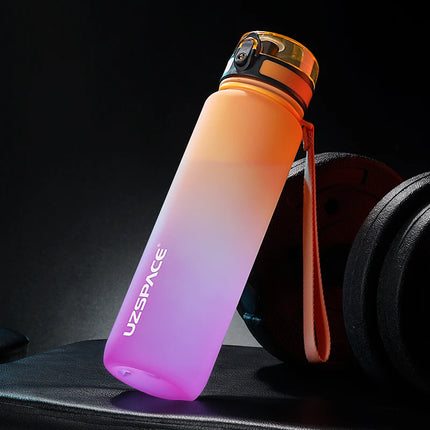 Gradient orange to pink water bottle with 'UZSPACE' branding on a dark background